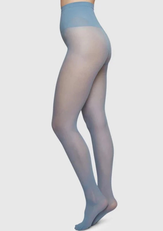 A model wearing Svea semi-sheer dusty blue tights