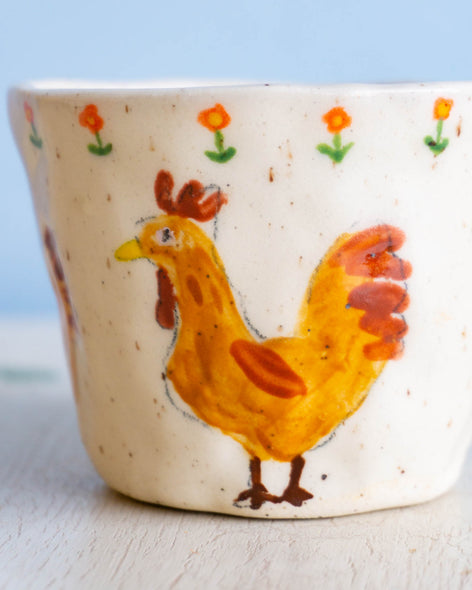 Close up on ceramic mug with hens
